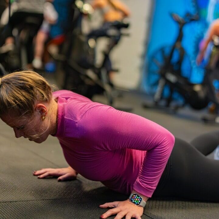 Woman doing a burpee broad jump.